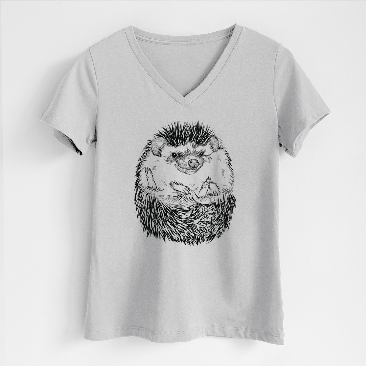 Lunar grey women's relaxed fit cotton V-neck t-shirt laid flat, printed with a detailed black ink illustration of a hedgehog curled up and facing forward.