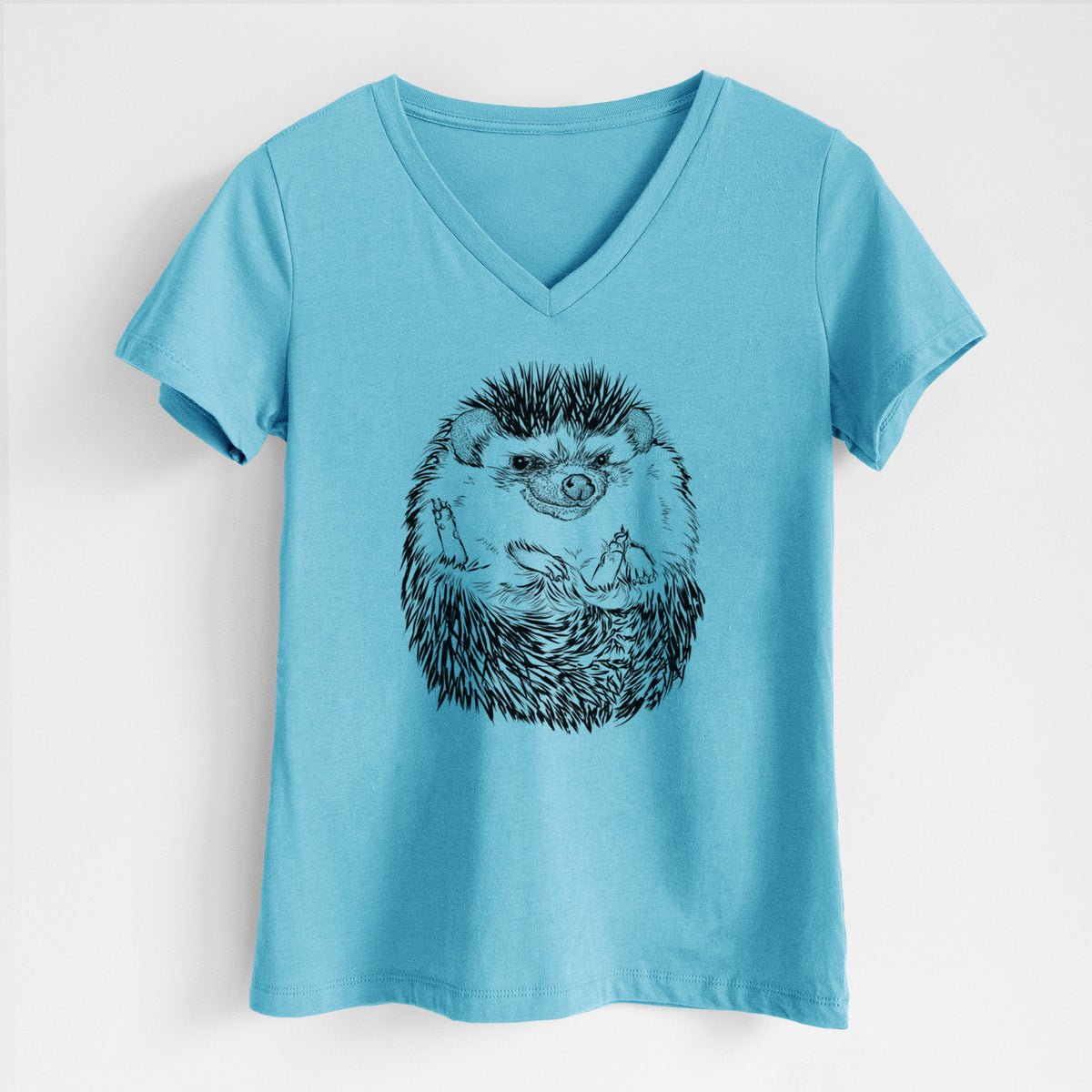 Turquoise women's relaxed fit cotton V-neck t-shirt laid flat, printed with a detailed black ink illustration of a hedgehog curled up and facing forward.