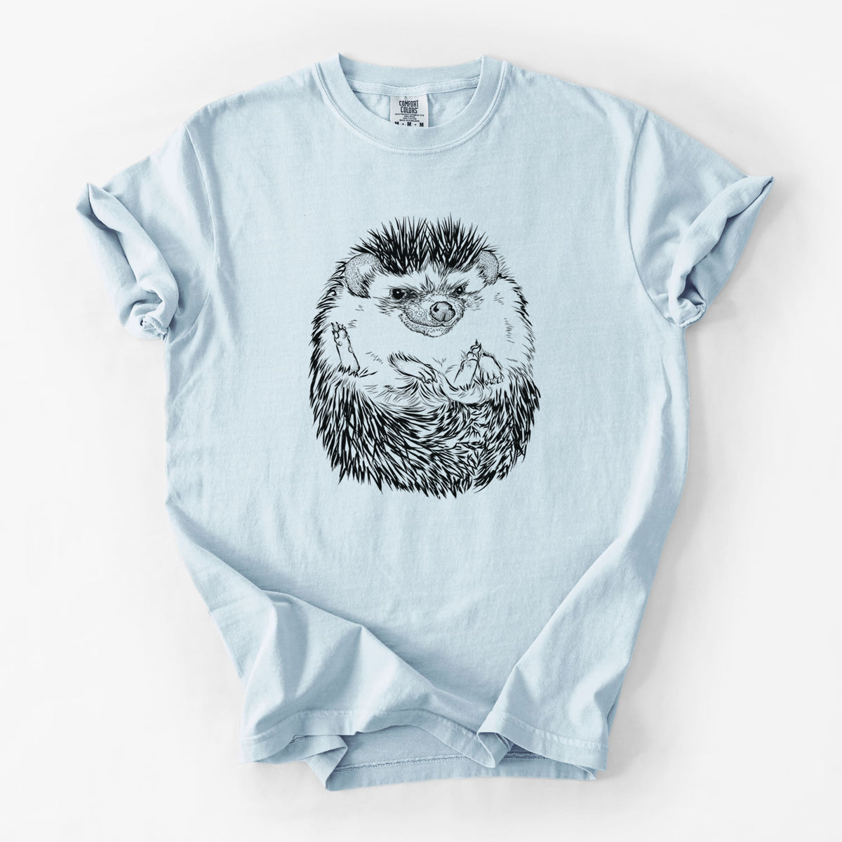 Chambray blue Comfort Colors t-shirt laid flat, printed with a detailed black ink illustration of a hedgehog curled up and facing forward.
