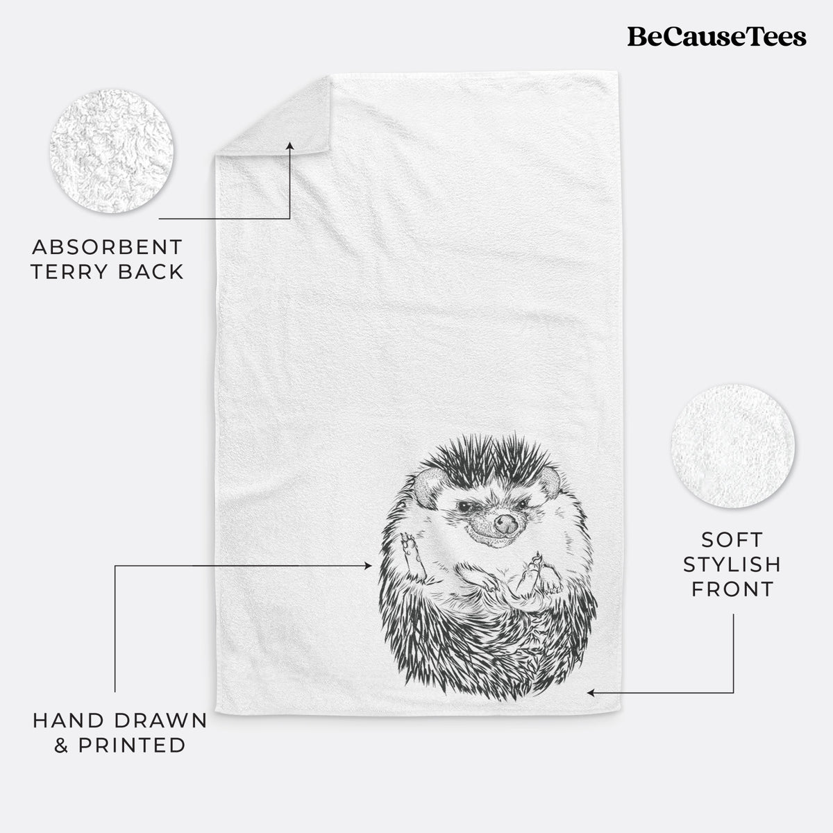 White hand towel printed with a detailed black ink illustration of a hedgehog curled up and facing forward.