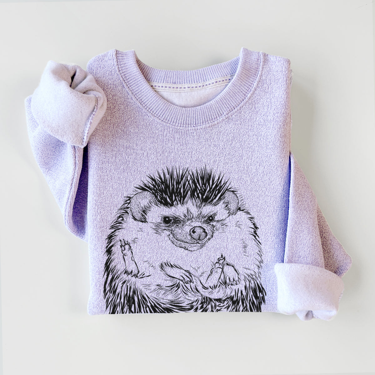 Ice purple knit sweatshirt printed with a detailed black ink illustration of a hedgehog curled up and facing forward, styled flat.