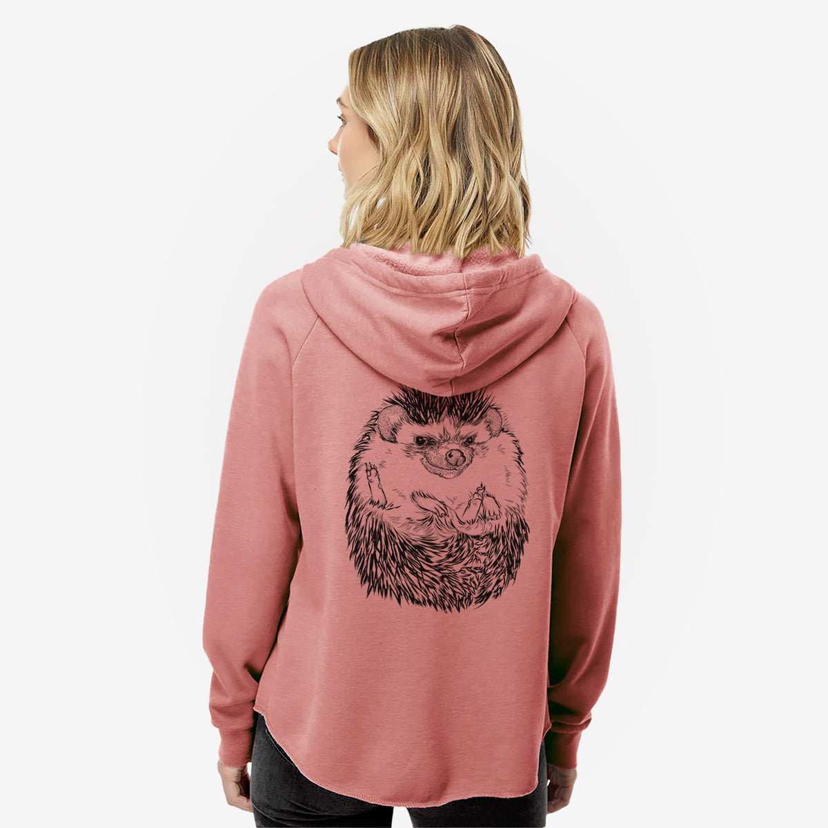 Woman wearing a dusty rose women's Cali Wave zip-up sweatshirt printed with a detailed black ink illustration of a hedgehog curled up and facing forward, seen from behind.