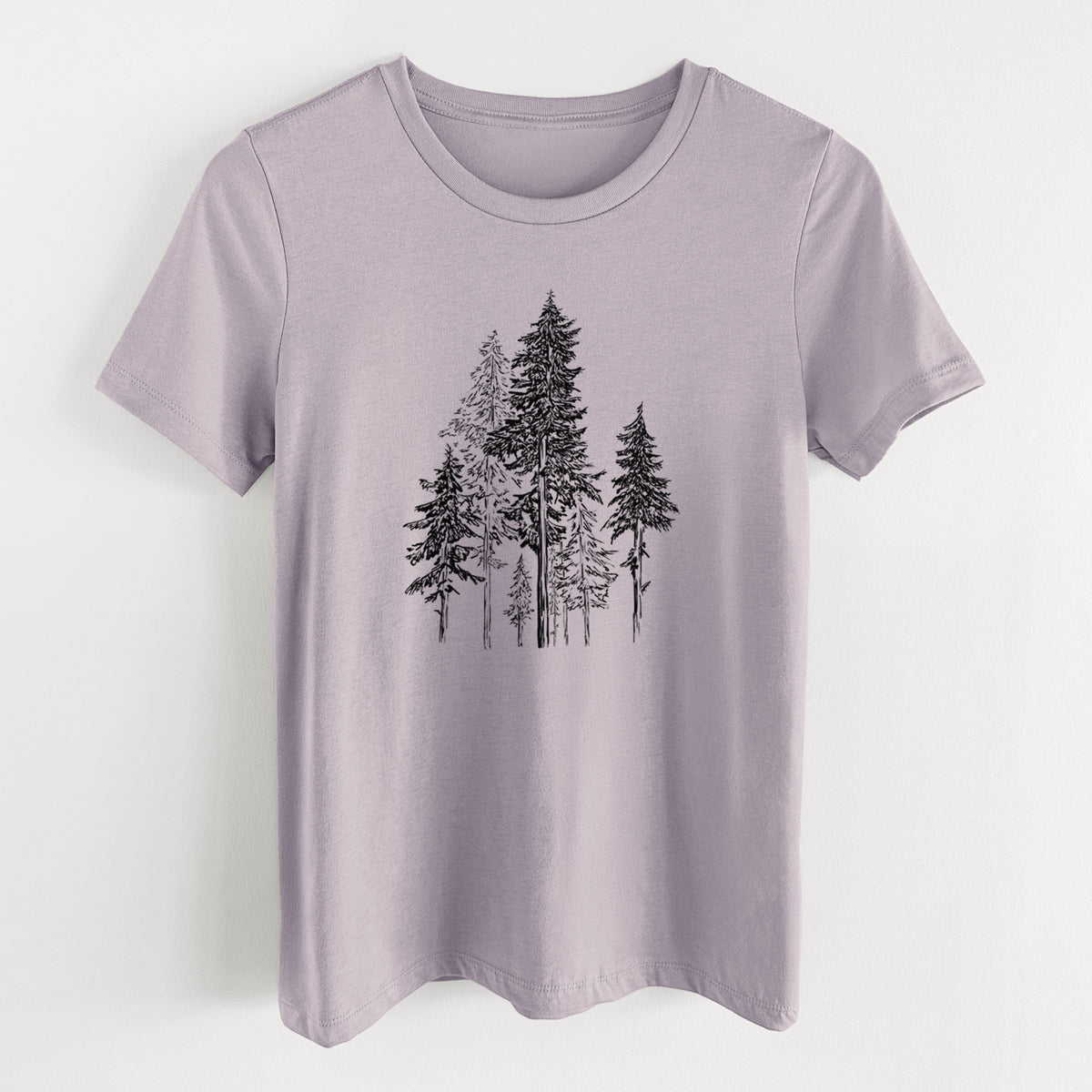 Light violet women's relaxed fit cotton t-shirt laid flat, printed with a black ink illustration of a forest of tall hemlock trees.