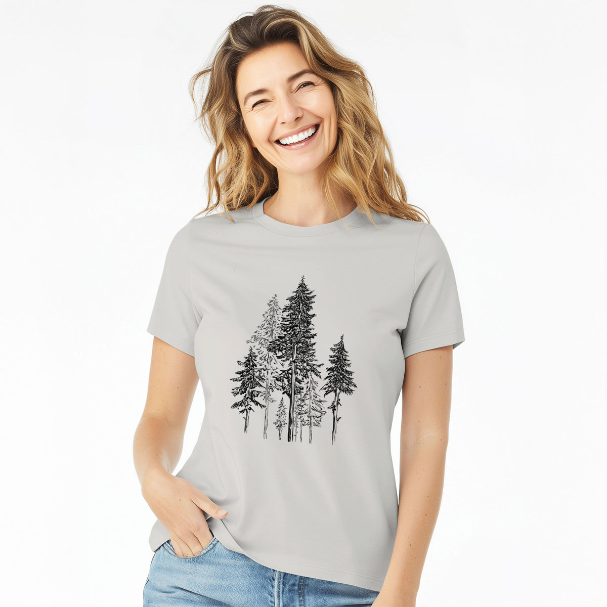 Woman wearing a lunar grey women's relaxed fit cotton t-shirt printed with a black ink illustration of a forest of tall hemlock trees.