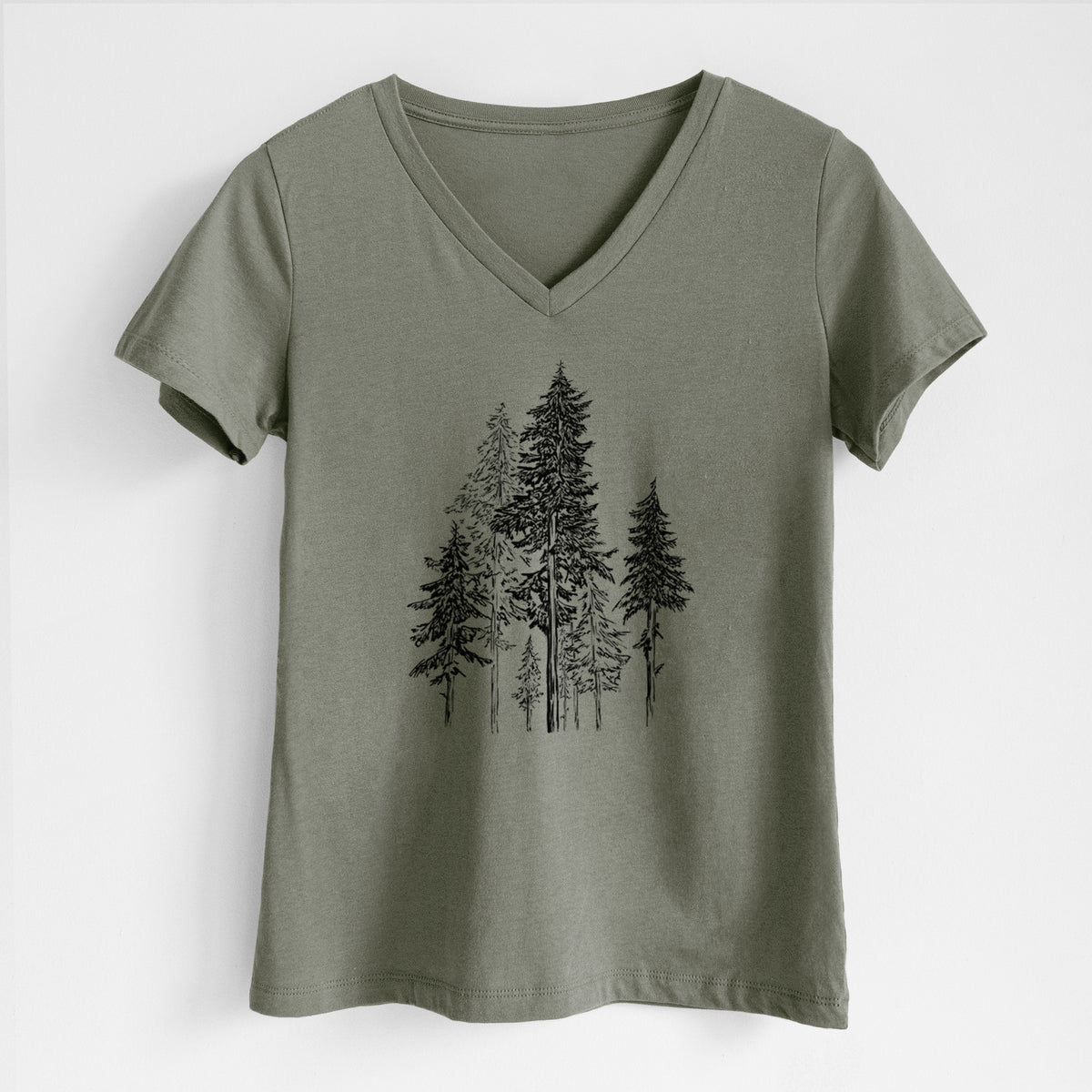 Military green women's relaxed fit cotton V-neck t-shirt laid flat, printed with a black ink illustration of a forest of tall hemlock trees.