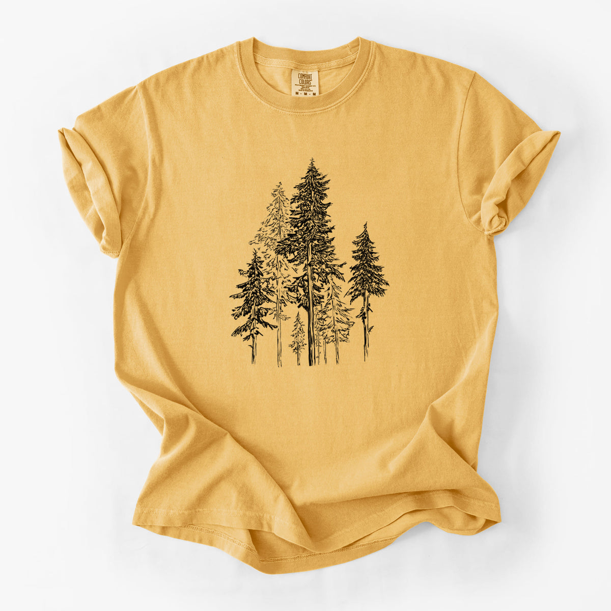 Golden wheat yellow Comfort Colors t-shirt laid flat, printed with a black ink illustration of a forest of tall hemlock trees.