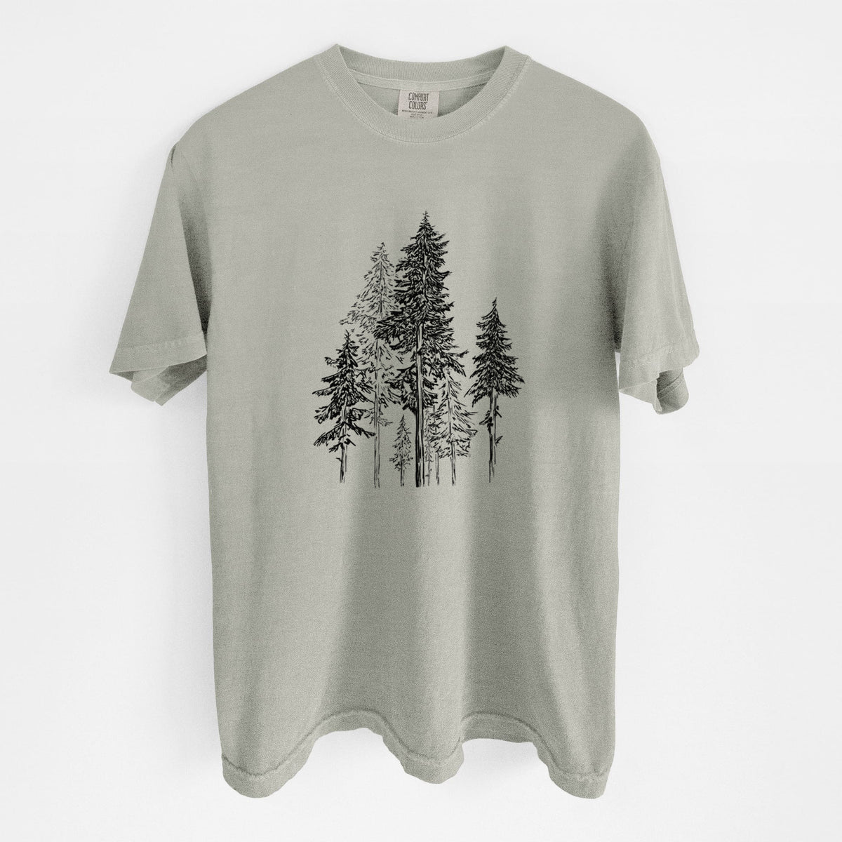 Sandstone beige Comfort Colors t-shirt laid flat, printed with a black ink illustration of a forest of tall hemlock trees.