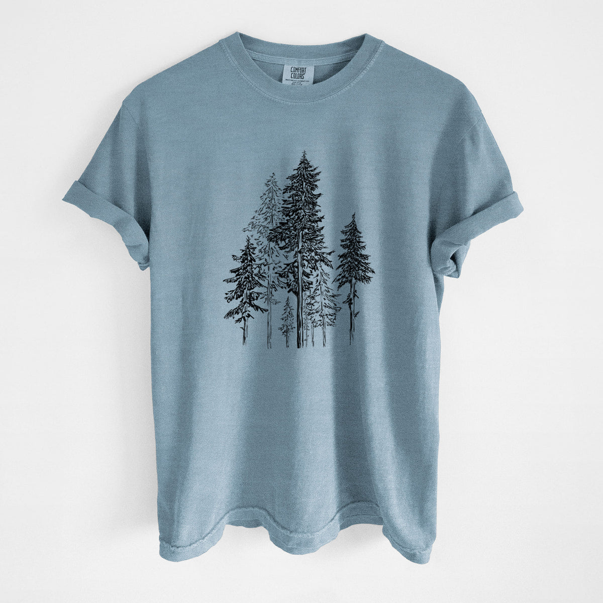 Steel blue Comfort Colors t-shirt laid flat, printed with a black ink illustration of a forest of tall hemlock trees.