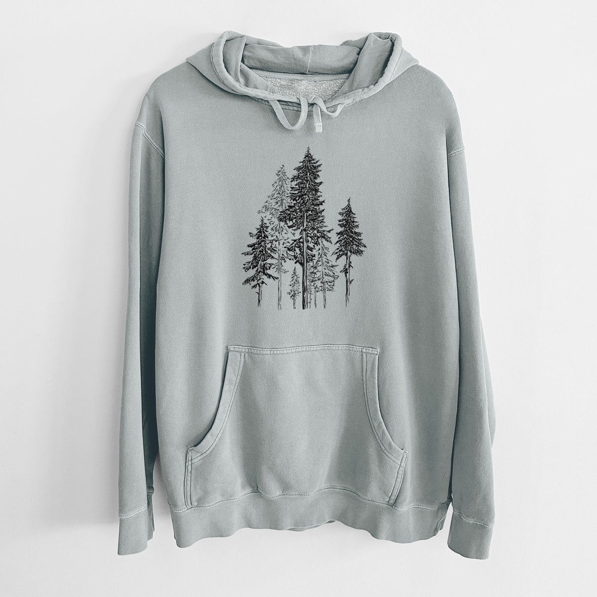 Sage green pigment dyed hoodie laid flat, printed with a black ink illustration of a forest of tall hemlock trees.