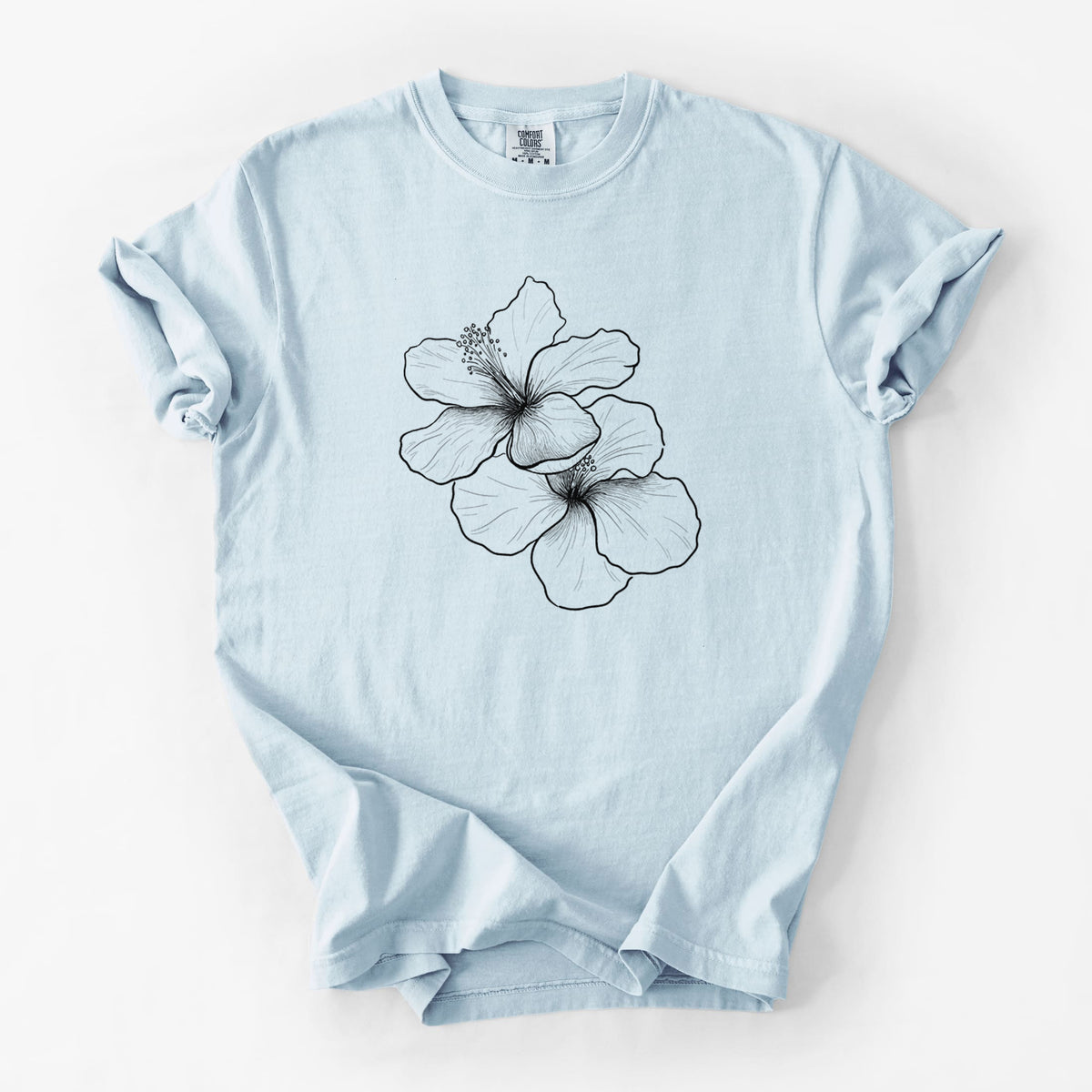 Chambray blue Comfort Colors t-shirt laid flat, printed with a black ink line drawing of three hibiscus flowers.