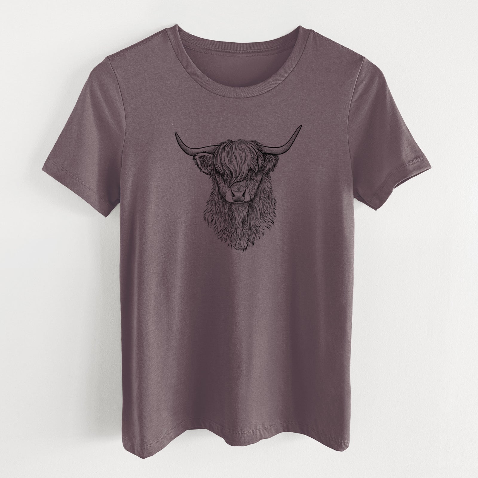 Purple storm women's relaxed fit cotton t-shirt laid flat, printed with a detailed black ink portrait of a shaggy highland cow with long curved horns.