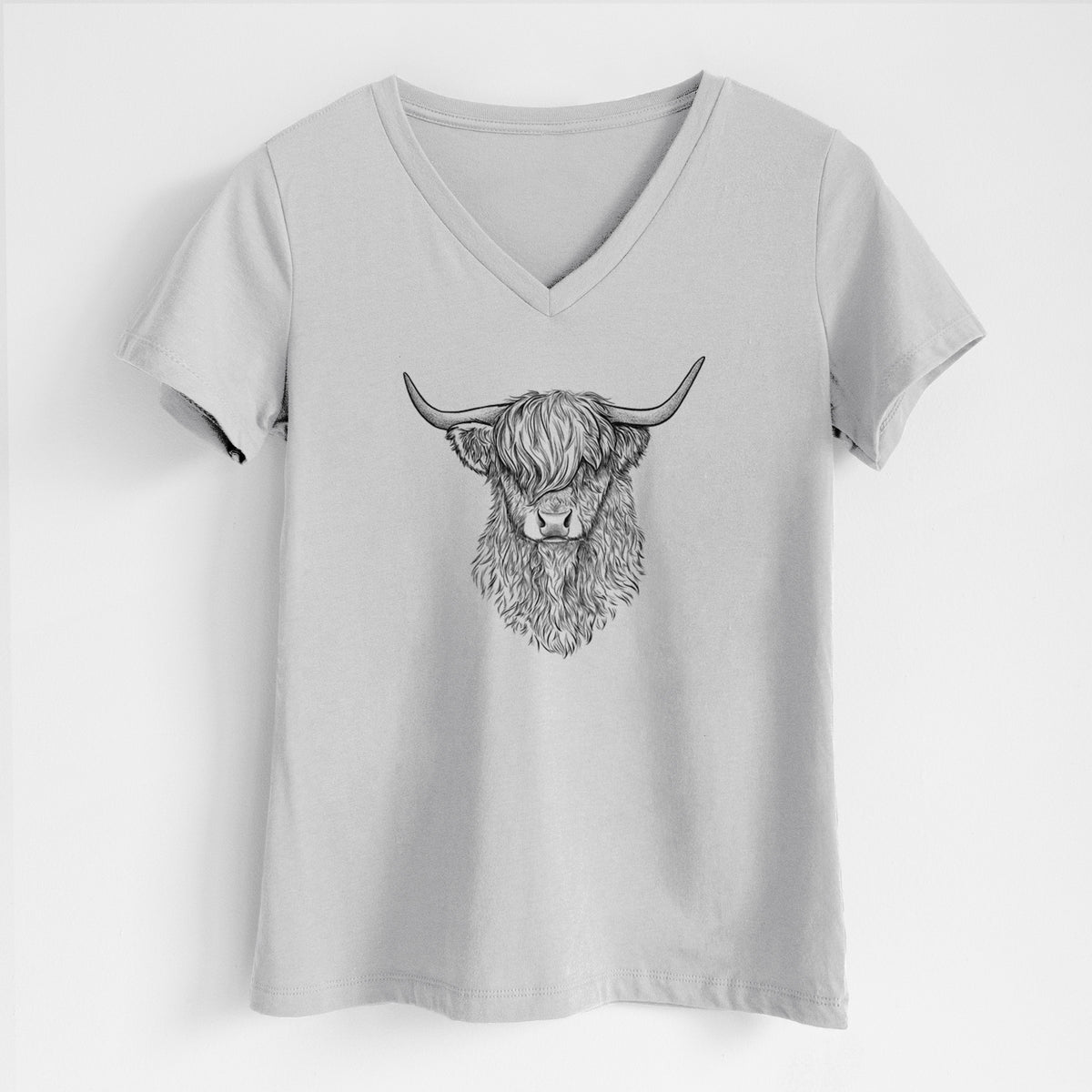 Lunar grey women's relaxed fit cotton V-neck t-shirt laid flat, printed with a detailed black ink portrait of a shaggy highland cow with long curved horns.