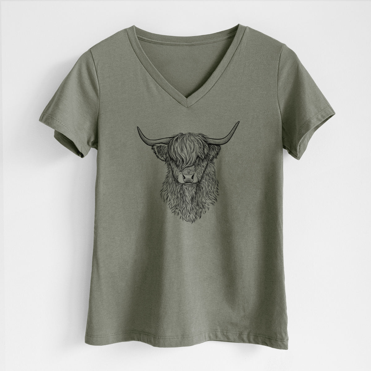 Military green women's relaxed fit cotton V-neck t-shirt laid flat, printed with a detailed black ink portrait of a shaggy highland cow with long curved horns.
