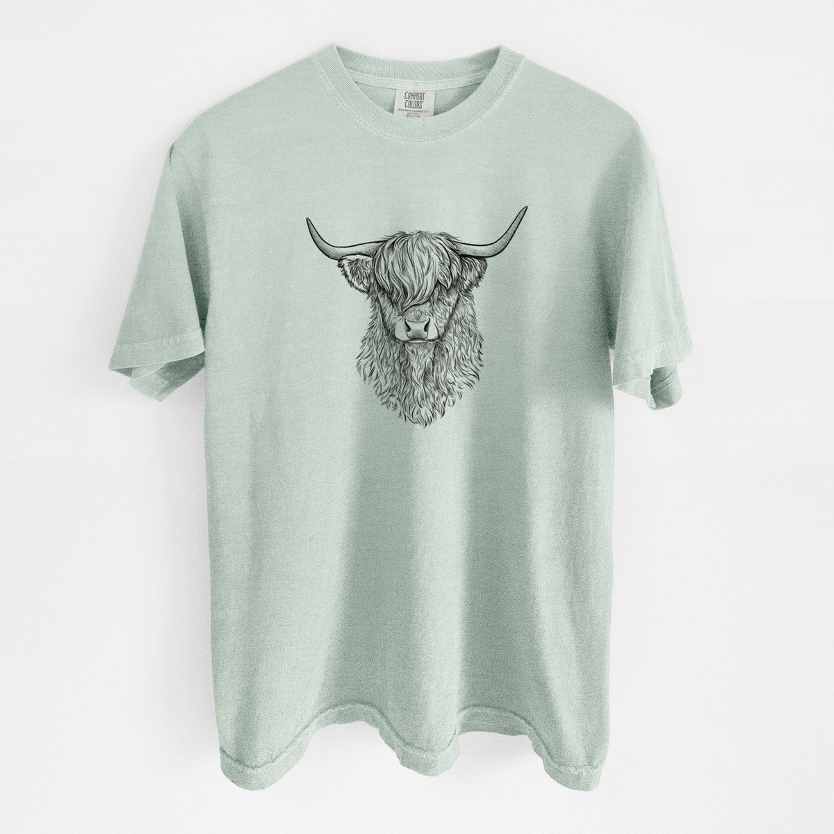 Bay green Comfort Colors t-shirt laid flat, printed with a detailed black ink portrait of a shaggy highland cow with long curved horns.
