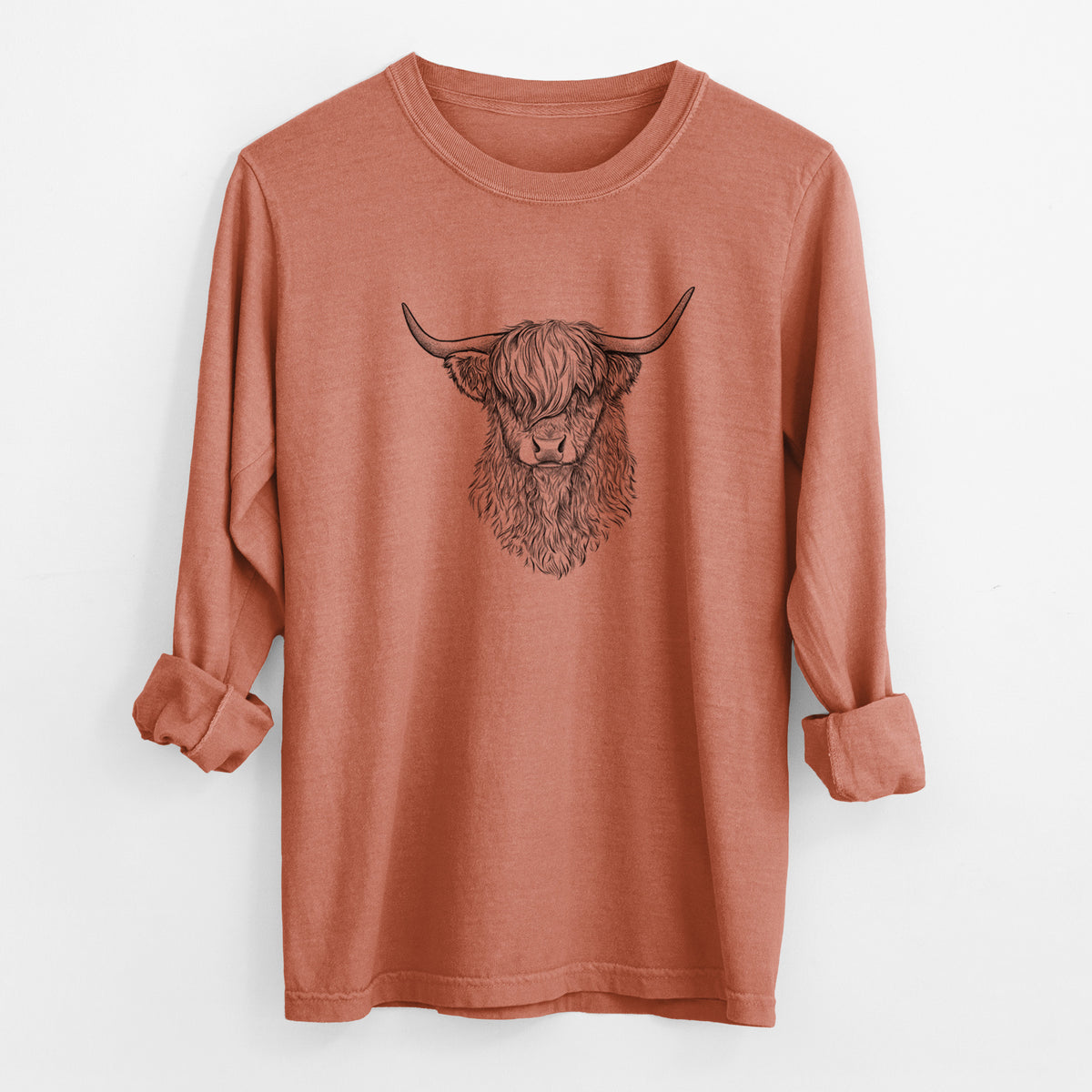 Yam burnt orange Comfort Colors long sleeve shirt laid flat with the cuffs rolled, printed with a detailed black ink portrait of a shaggy highland cow with long curved horns.