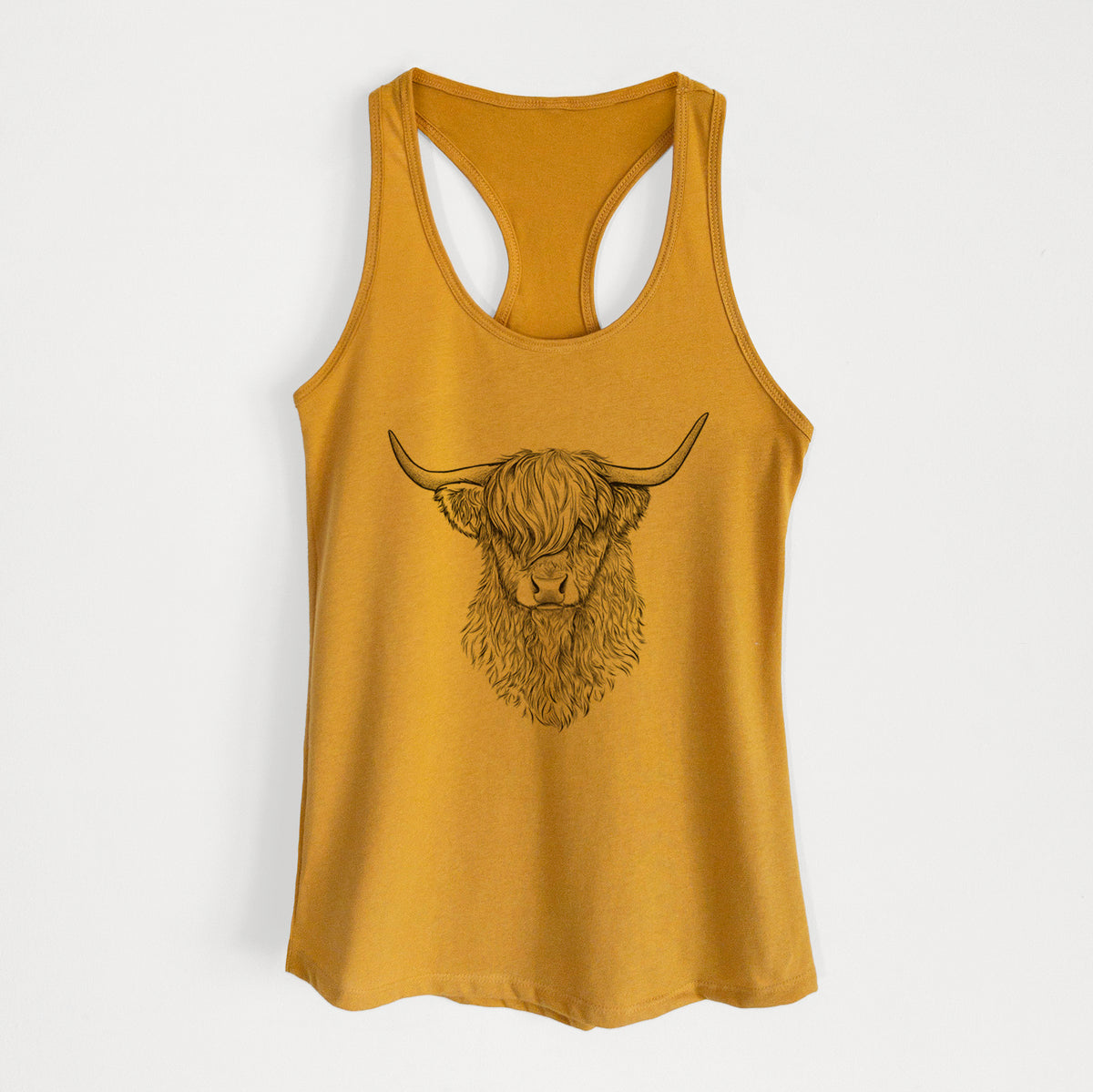Gold women's racerback tank top laid flat, printed with a detailed black ink portrait of a shaggy highland cow with long curved horns.