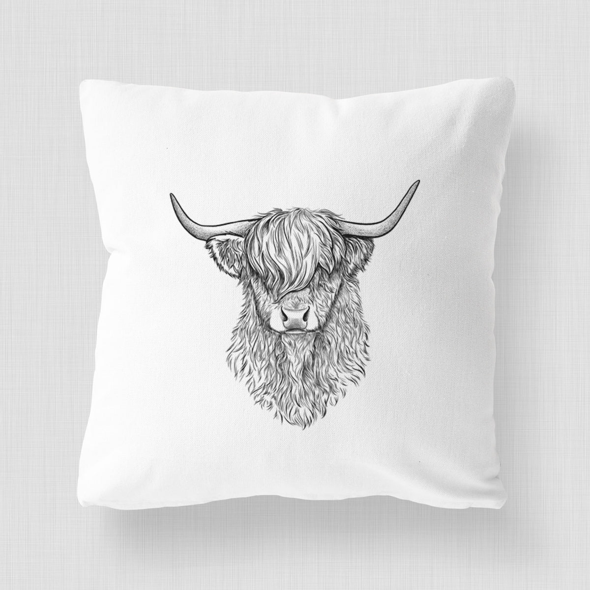 White pillow cover printed with a detailed black ink portrait of a shaggy highland cow with long curved horns.