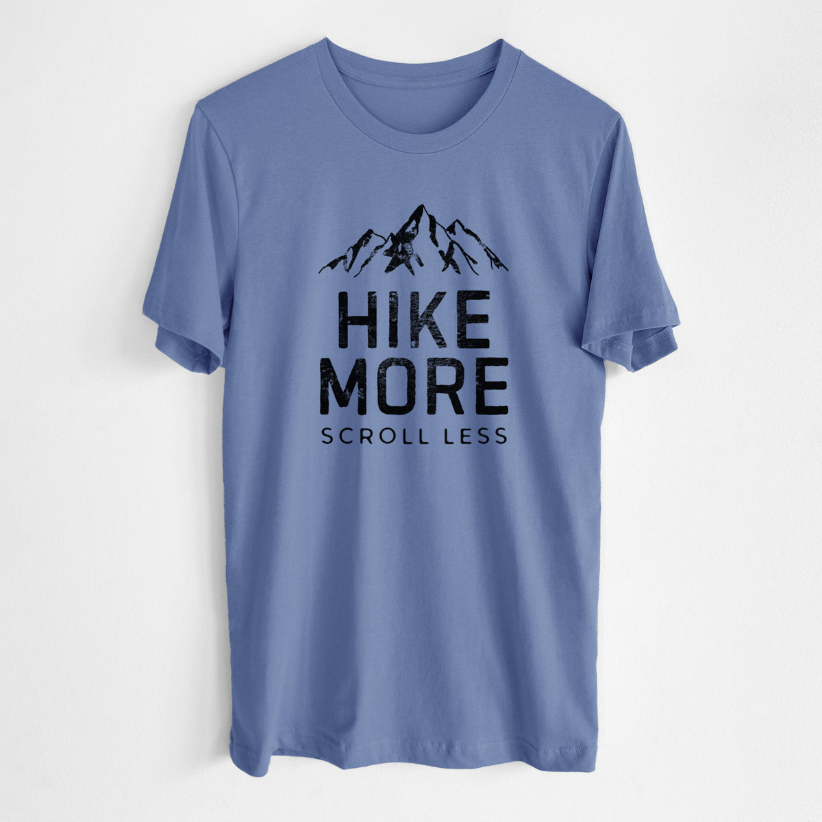 Blue bell lightweight cotton t-shirt laid flat, printed with black mountain peaks above the bold words Hike More, Scroll Less.