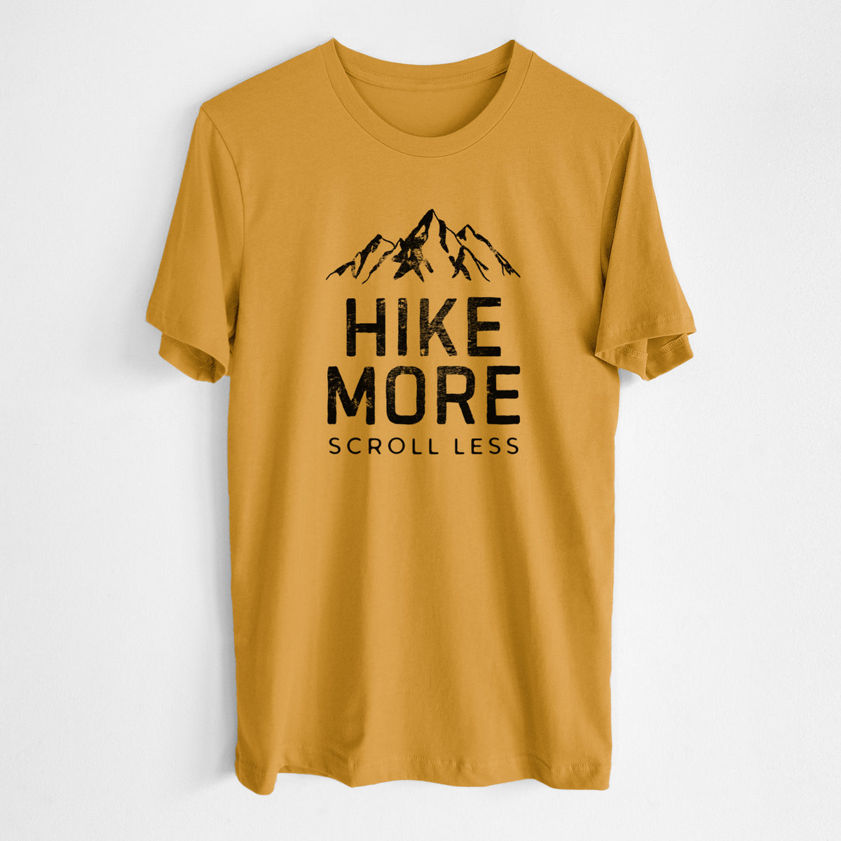 Honeycomb yellow lightweight cotton t-shirt laid flat, printed with black mountain peaks above the bold words Hike More, Scroll Less.