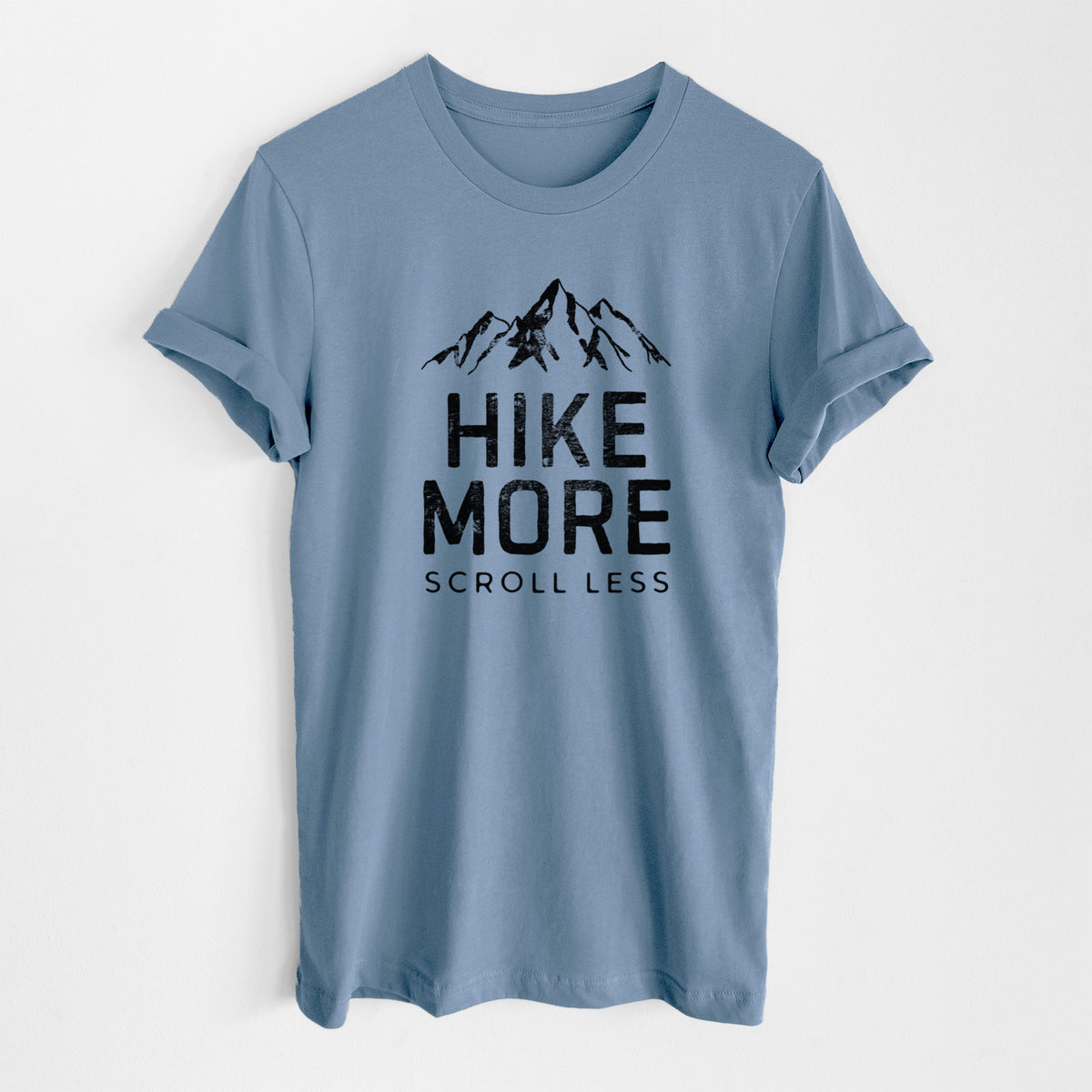 Steel blue lightweight cotton t-shirt laid flat, printed with black mountain peaks above the bold words Hike More, Scroll Less.