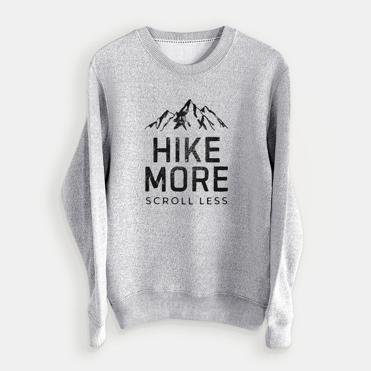 Salt and pepper knit sweatshirt laid flat, printed with black mountain peaks above the bold words Hike More, Scroll Less.