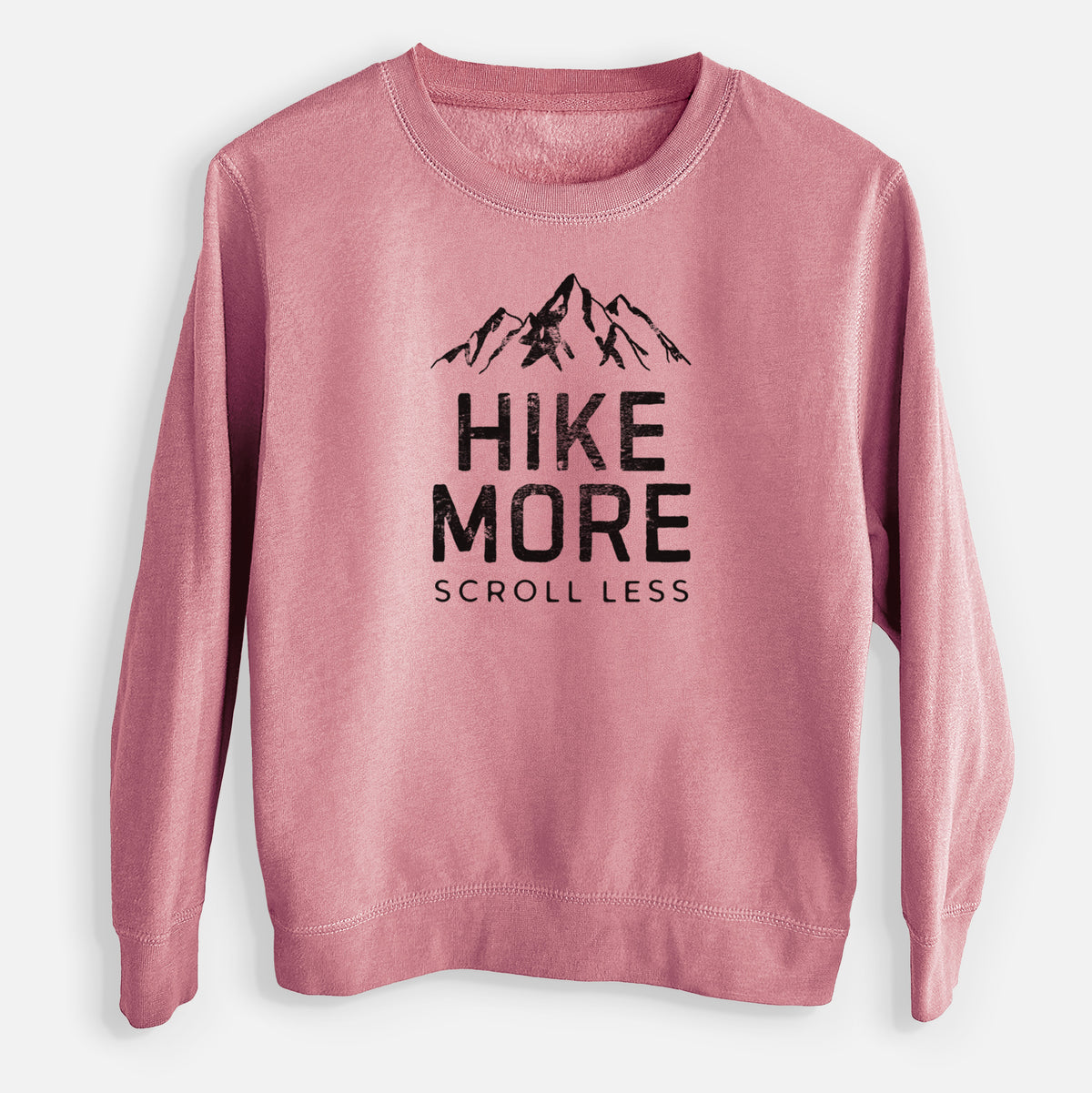 Mauve pink youth crewneck sweatshirt laid flat, printed with black mountain peaks above the bold words Hike More, Scroll Less.