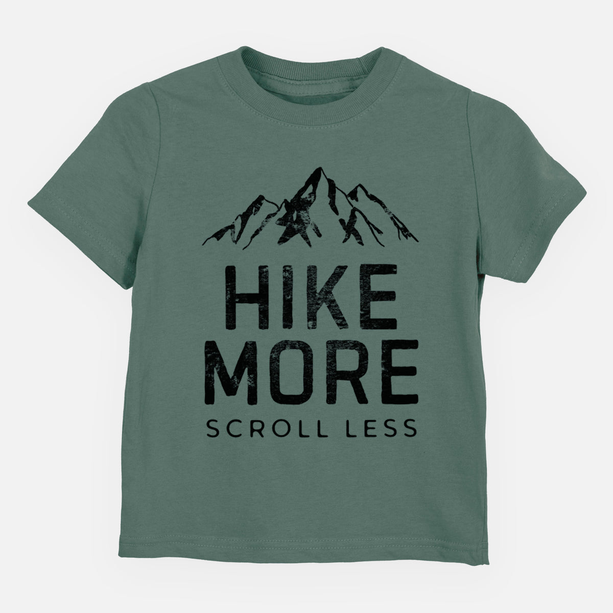 Basil green toddler t-shirt laid flat, printed with black mountain peaks above the bold words Hike More, Scroll Less.