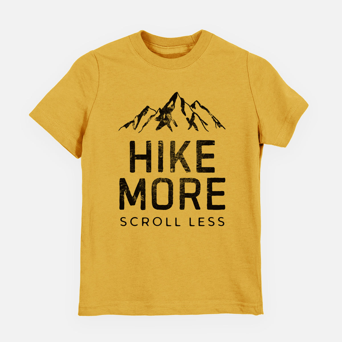 Honeycomb yellow youth t-shirt laid flat, printed with black mountain peaks above the bold words Hike More, Scroll Less.