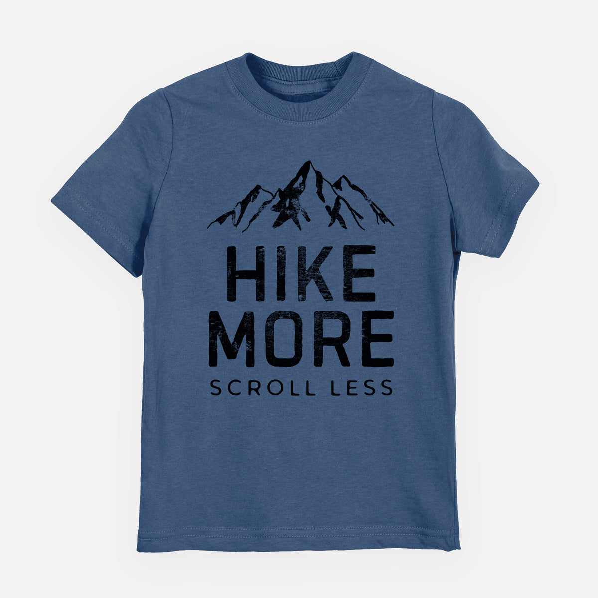 Indigo blue youth t-shirt laid flat, printed with black mountain peaks above the bold words Hike More, Scroll Less.