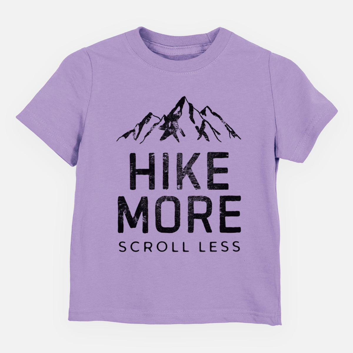 Lavender toddler t-shirt laid flat, printed with black mountain peaks above the bold words Hike More, Scroll Less.
