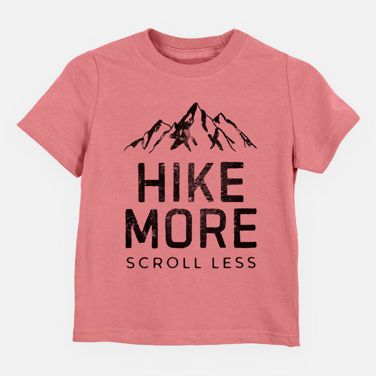 Mauve pink toddler t-shirt laid flat, printed with black mountain peaks above the bold words Hike More, Scroll Less.