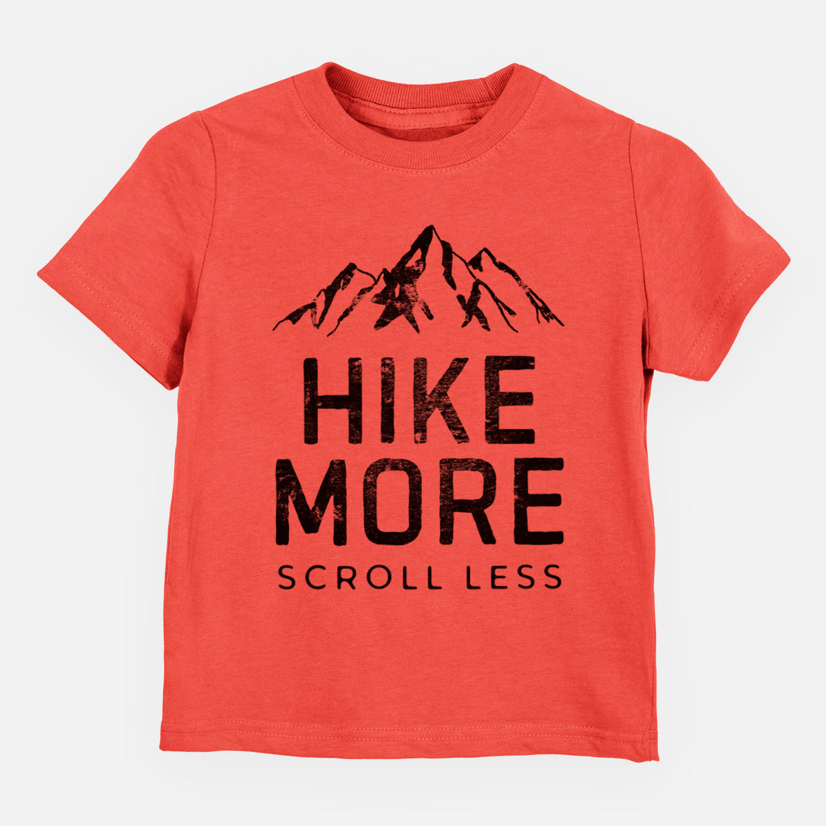 Passionfruit pink toddler t-shirt laid flat, printed with black mountain peaks above the bold words Hike More, Scroll Less.