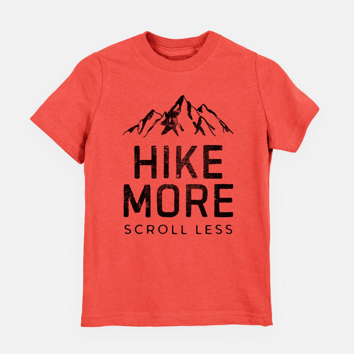 Passionfruit pink youth t-shirt laid flat, printed with black mountain peaks above the bold words Hike More, Scroll Less.