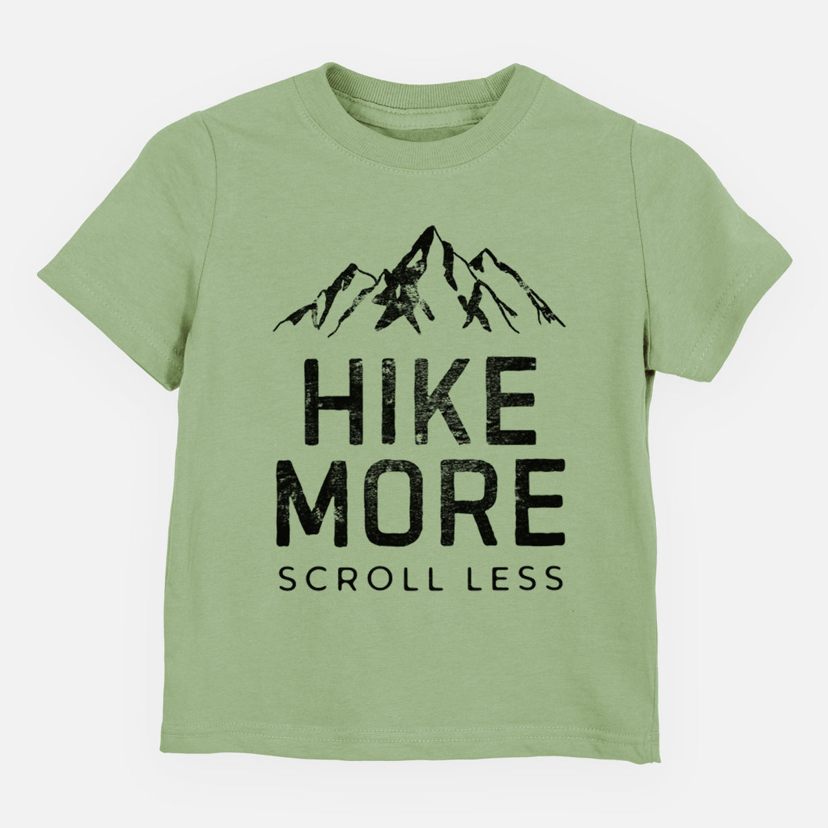 Sage green toddler t-shirt laid flat, printed with black mountain peaks above the bold words Hike More, Scroll Less.