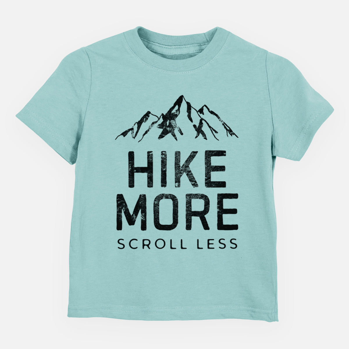 Saltwater toddler t-shirt laid flat, printed with black mountain peaks above the bold words Hike More, Scroll Less.