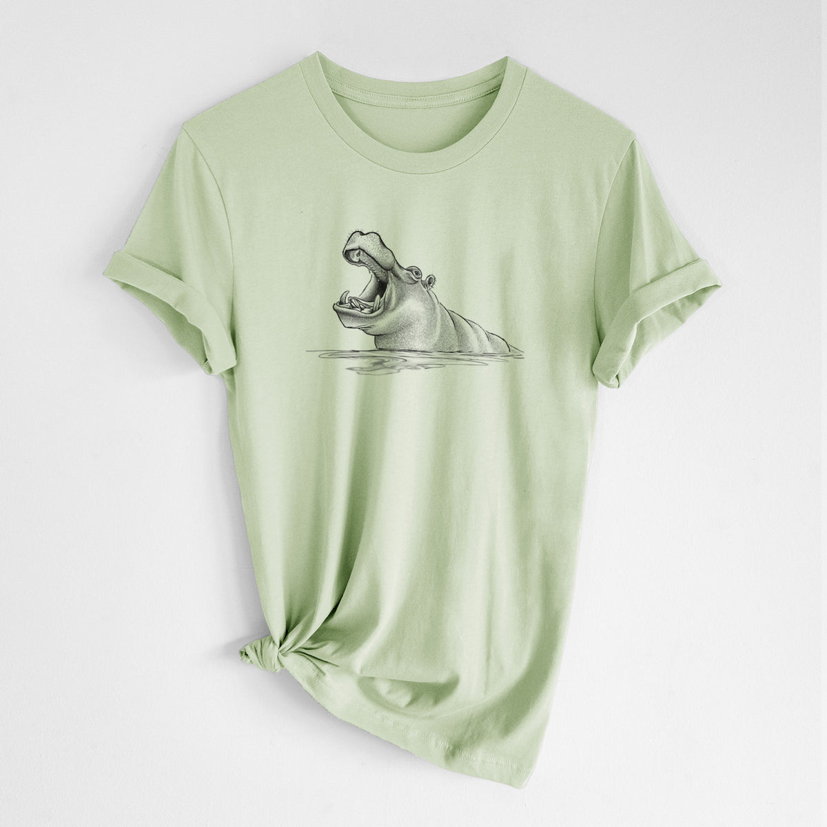 Spring green lightweight cotton t-shirt laid flat with the sleeves rolled, printed with a black ink illustration of a hippo yawning with its mouth wide open, half submerged in water.