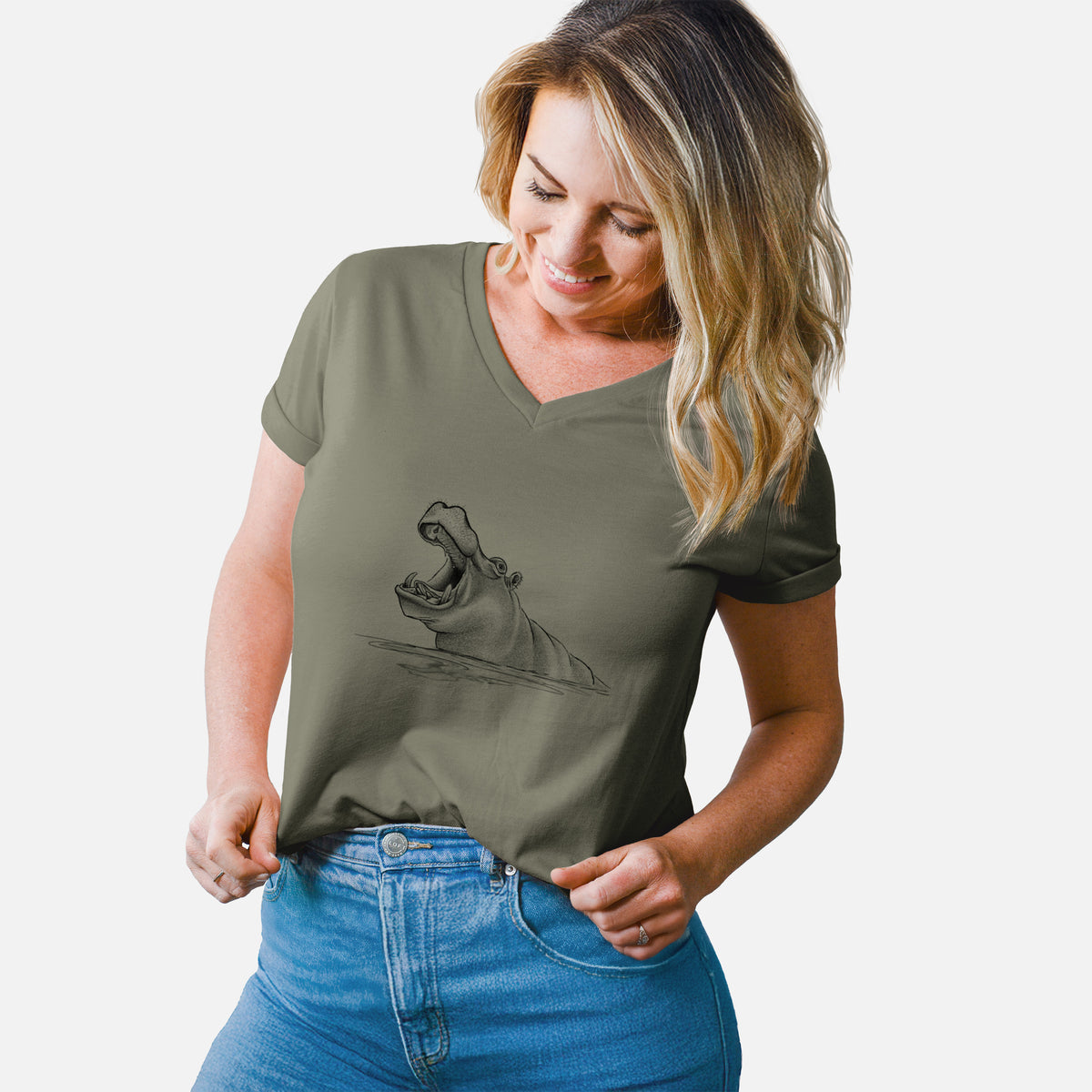Woman wearing a military green women's relaxed fit cotton V-neck t-shirt printed with a black ink illustration of a hippo yawning with its mouth wide open, half submerged in water.