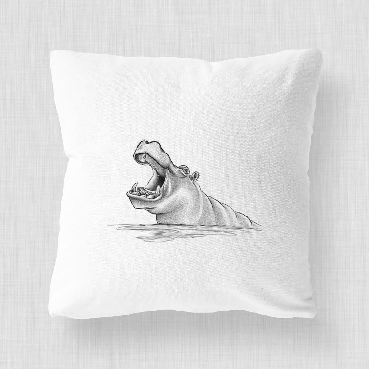 White pillow cover printed with a black ink illustration of a hippo yawning with its mouth wide open, half submerged in water.