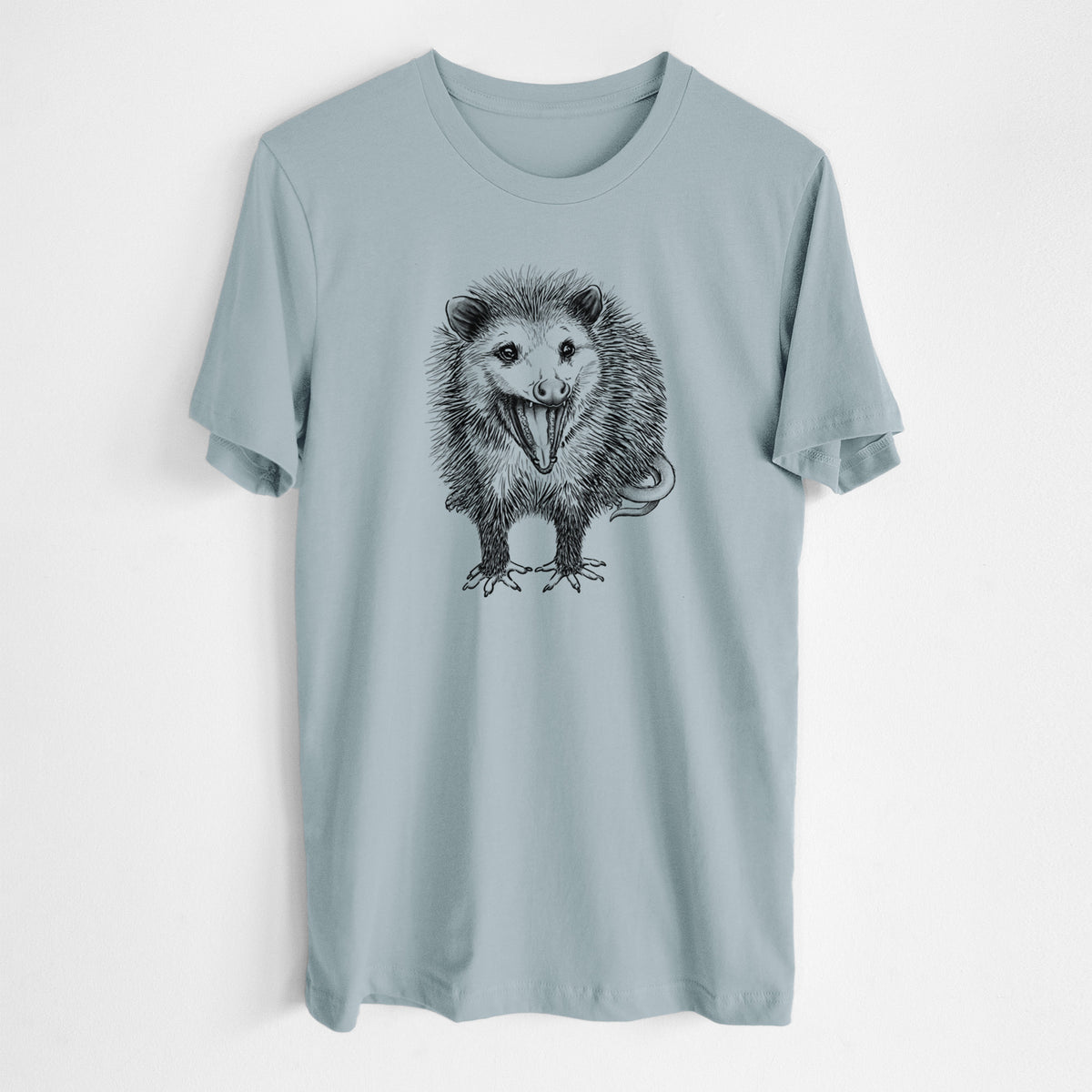 Vintage denim lightweight cotton t-shirt laid flat, printed with a detailed black ink illustration of an opossum standing and facing forward, mouth open wide in a hiss, with shaggy fur and its tail curled behind.