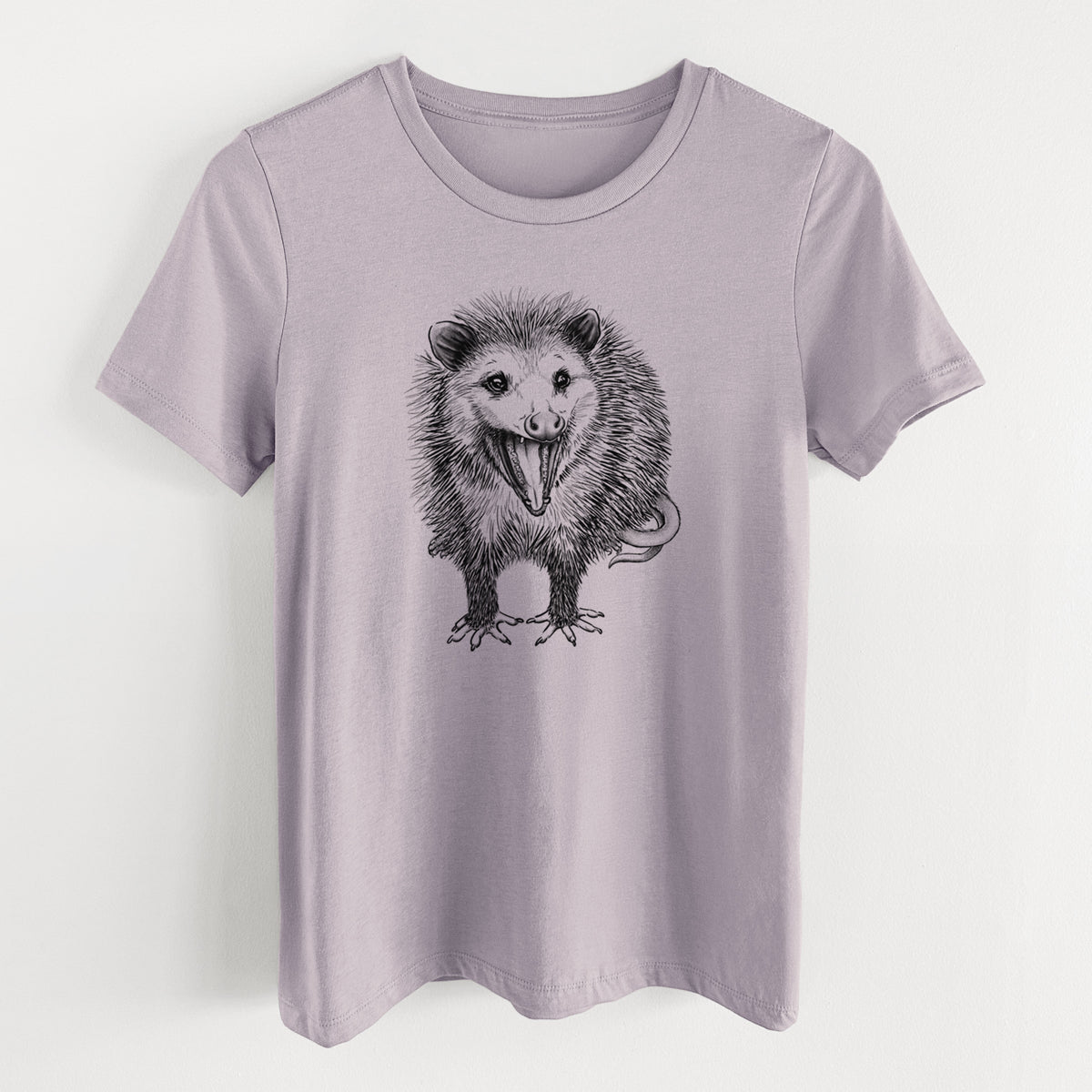 Light violet women's relaxed fit cotton t-shirt laid flat, printed with a detailed black ink illustration of an opossum standing and facing forward, mouth open wide in a hiss, with shaggy fur and its tail curled behind.