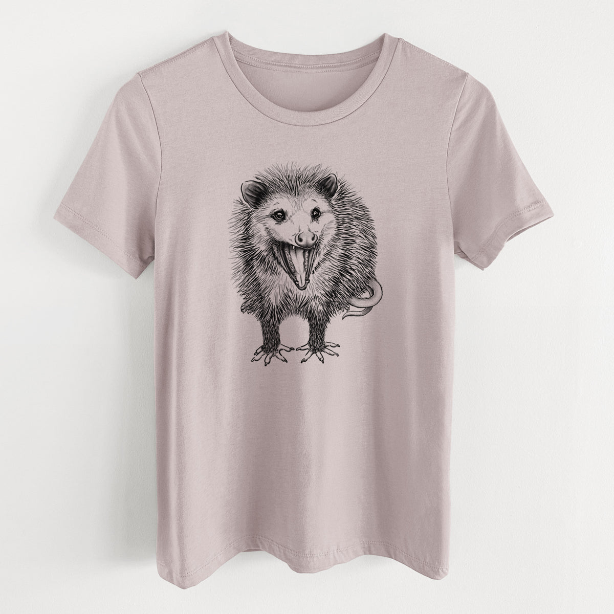 Pink gravel women's relaxed fit cotton t-shirt laid flat, printed with a detailed black ink illustration of an opossum standing and facing forward, mouth open wide in a hiss, with shaggy fur and its tail curled behind.