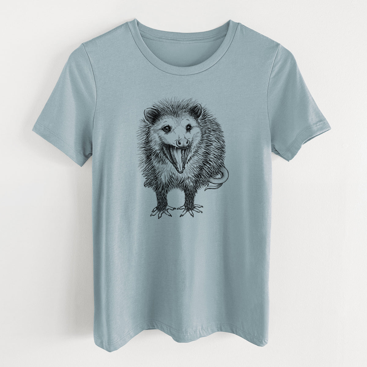 Vintage denim women's relaxed fit cotton t-shirt laid flat, printed with a detailed black ink illustration of an opossum standing and facing forward, mouth open wide in a hiss, with shaggy fur and its tail curled behind.