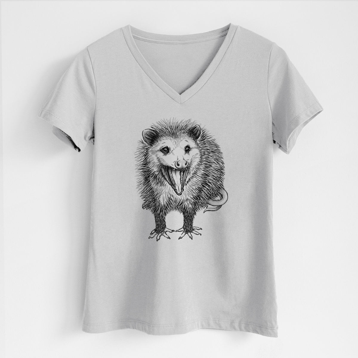 Lunar grey women's relaxed fit cotton V-neck t-shirt laid flat, printed with a detailed black ink illustration of an opossum standing and facing forward, mouth open wide in a hiss, with shaggy fur and its tail curled behind.