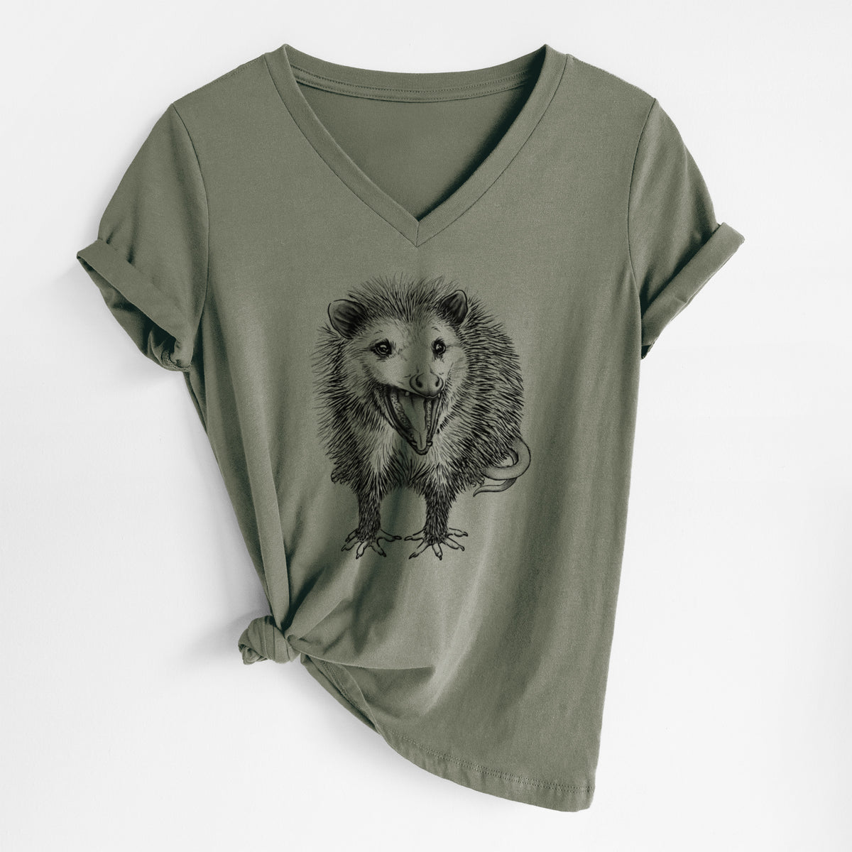 Military green women's relaxed fit cotton V-neck t-shirt laid flat, printed with a detailed black ink illustration of an opossum standing and facing forward, mouth open wide in a hiss, with shaggy fur and its tail curled behind.