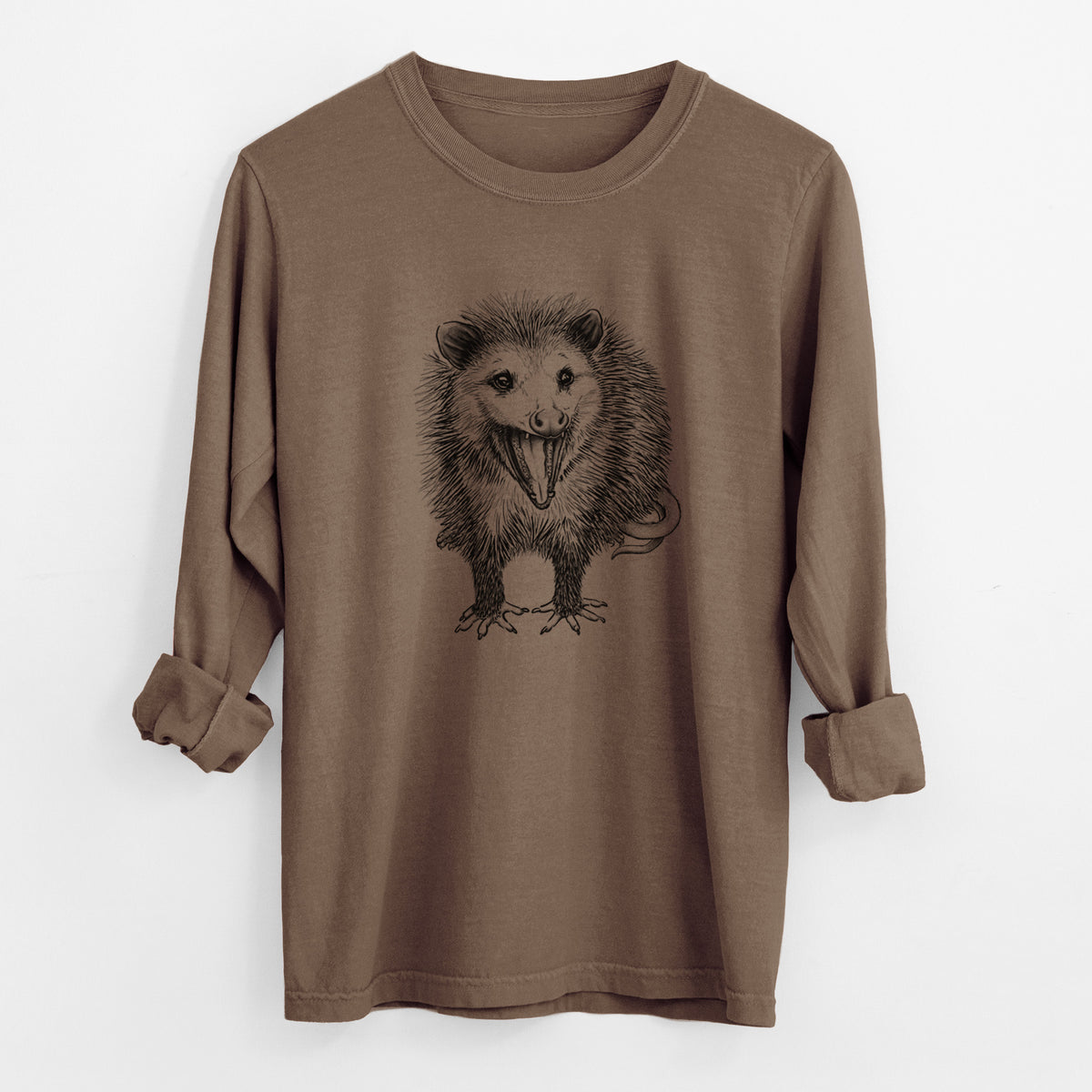 Espresso brown Comfort Colors long sleeve shirt laid flat with the cuffs rolled, printed with a detailed black ink illustration of an opossum standing and facing forward, mouth open wide in a hiss, with shaggy fur and its tail curled behind.