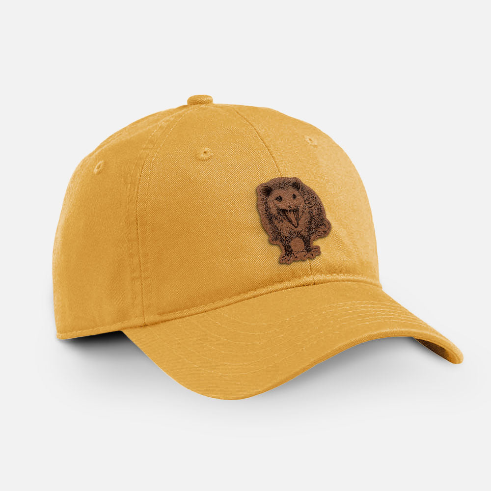 Navy cotton baseball hat with a detailed black ink illustration of an opossum standing and facing forward, mouth open wide in a hiss, with shaggy fur and its tail curled behind on the front.