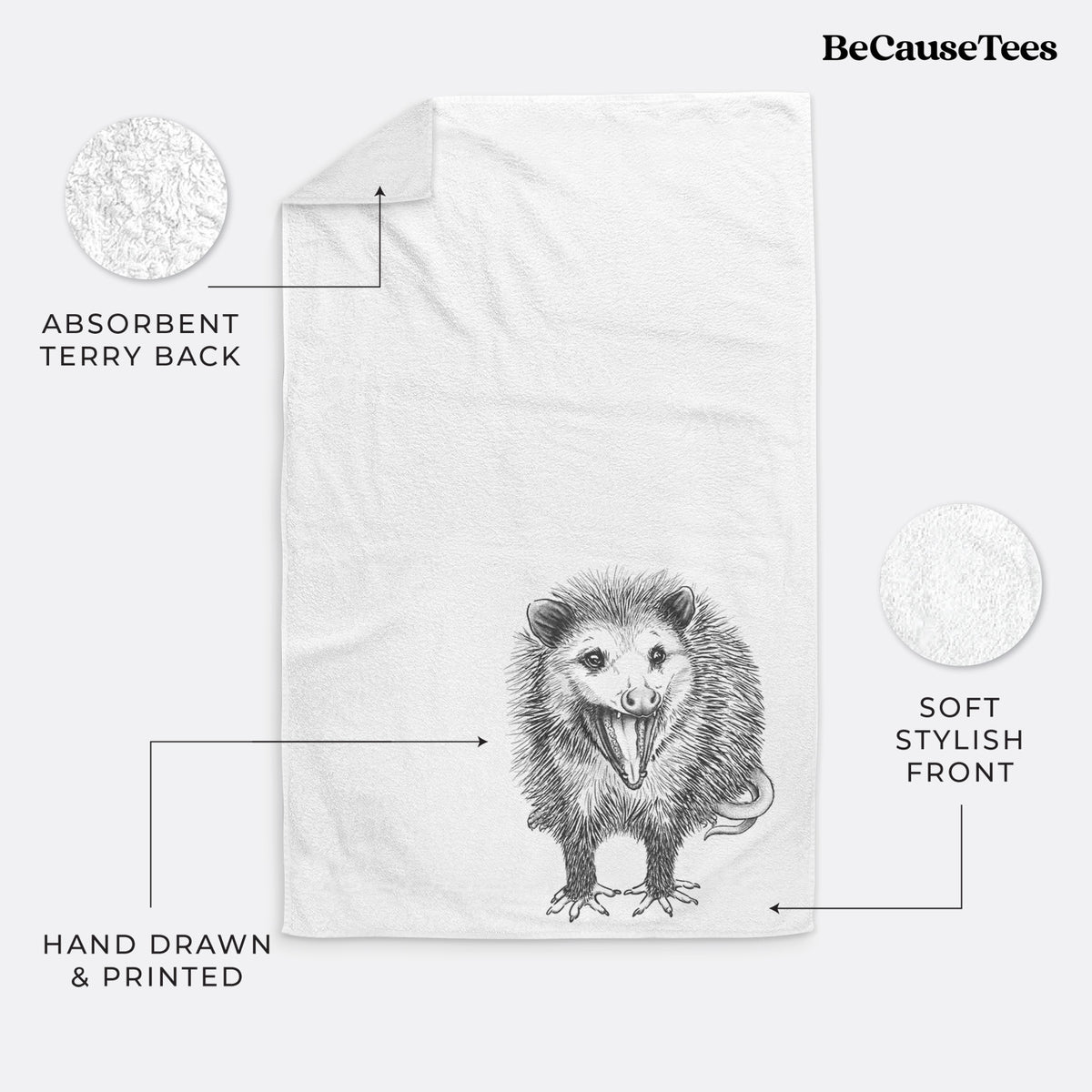 White hand towel printed with a detailed black ink illustration of an opossum standing and facing forward, mouth open wide in a hiss, with shaggy fur and its tail curled behind.