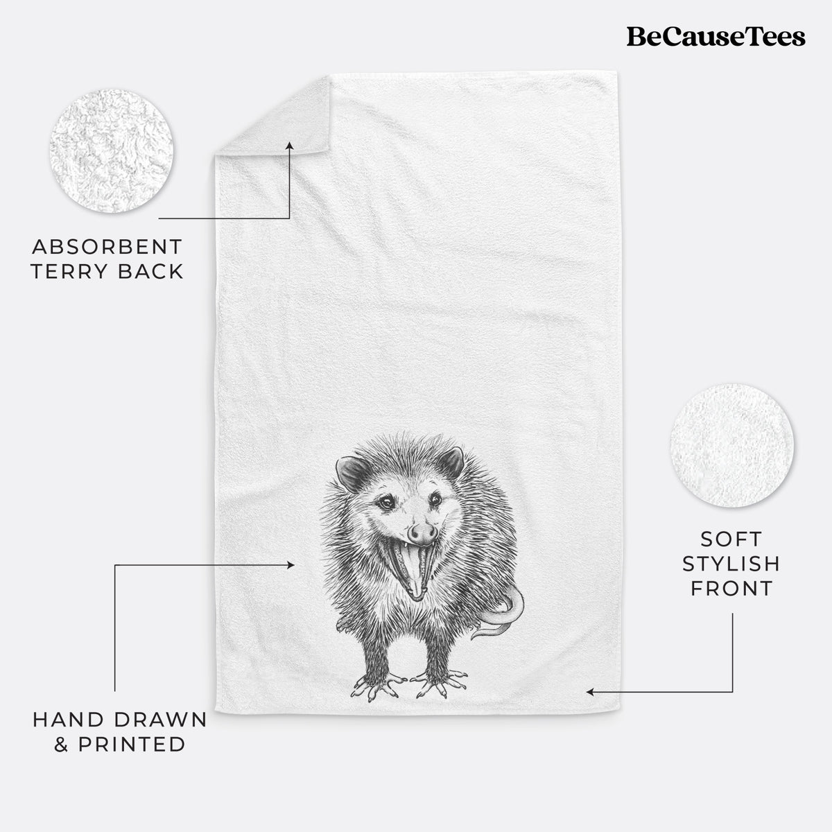 White hand towel printed with a detailed black ink illustration of an opossum standing and facing forward, mouth open wide in a hiss, with shaggy fur and its tail curled behind.