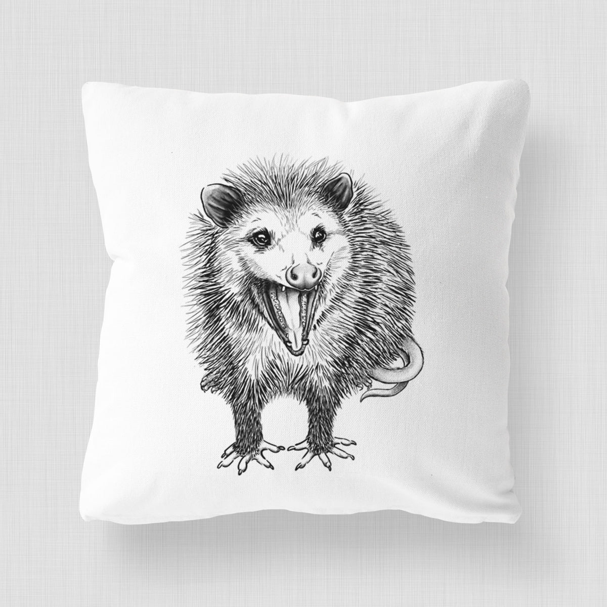 White pillow cover printed with a detailed black ink illustration of an opossum standing and facing forward, mouth open wide in a hiss, with shaggy fur and its tail curled behind.