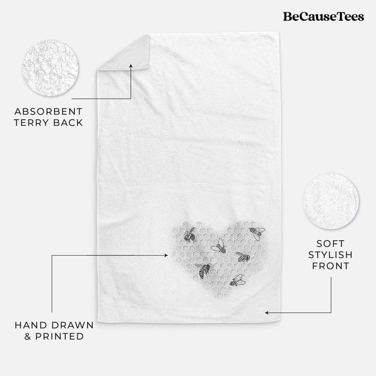 White hand towel printed with a black ink heart made of honeycomb cells with small bees crawling across it.